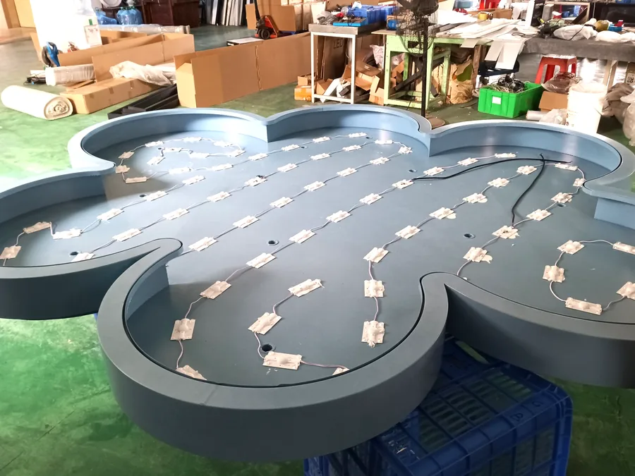 LED module layout being wired inside a custom cloud-shaped fixture body