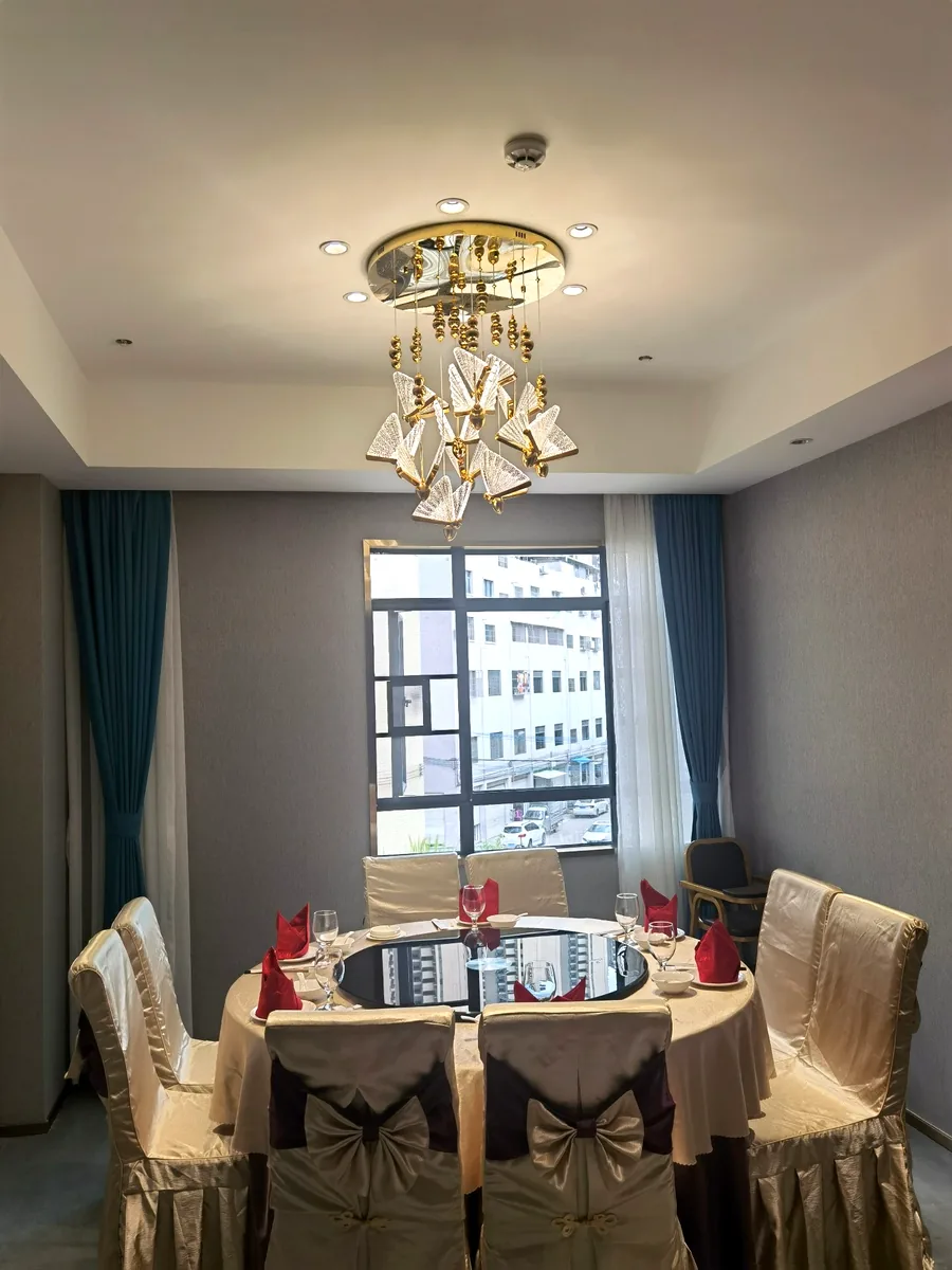 Private dining room — gold butterfly crystal chandelier over a round banquet table